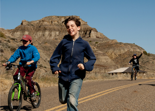 Three children playing outside.